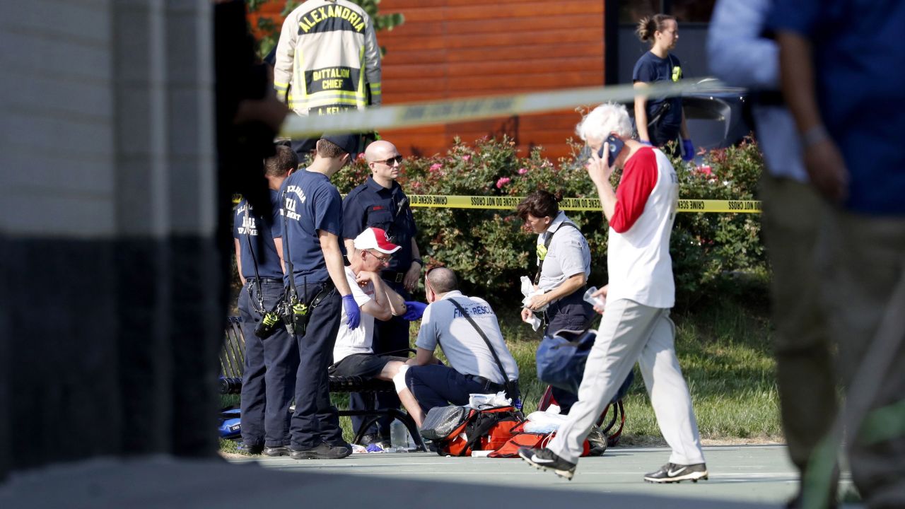 A person is treated by emergency workers at the scene of the shooting.
