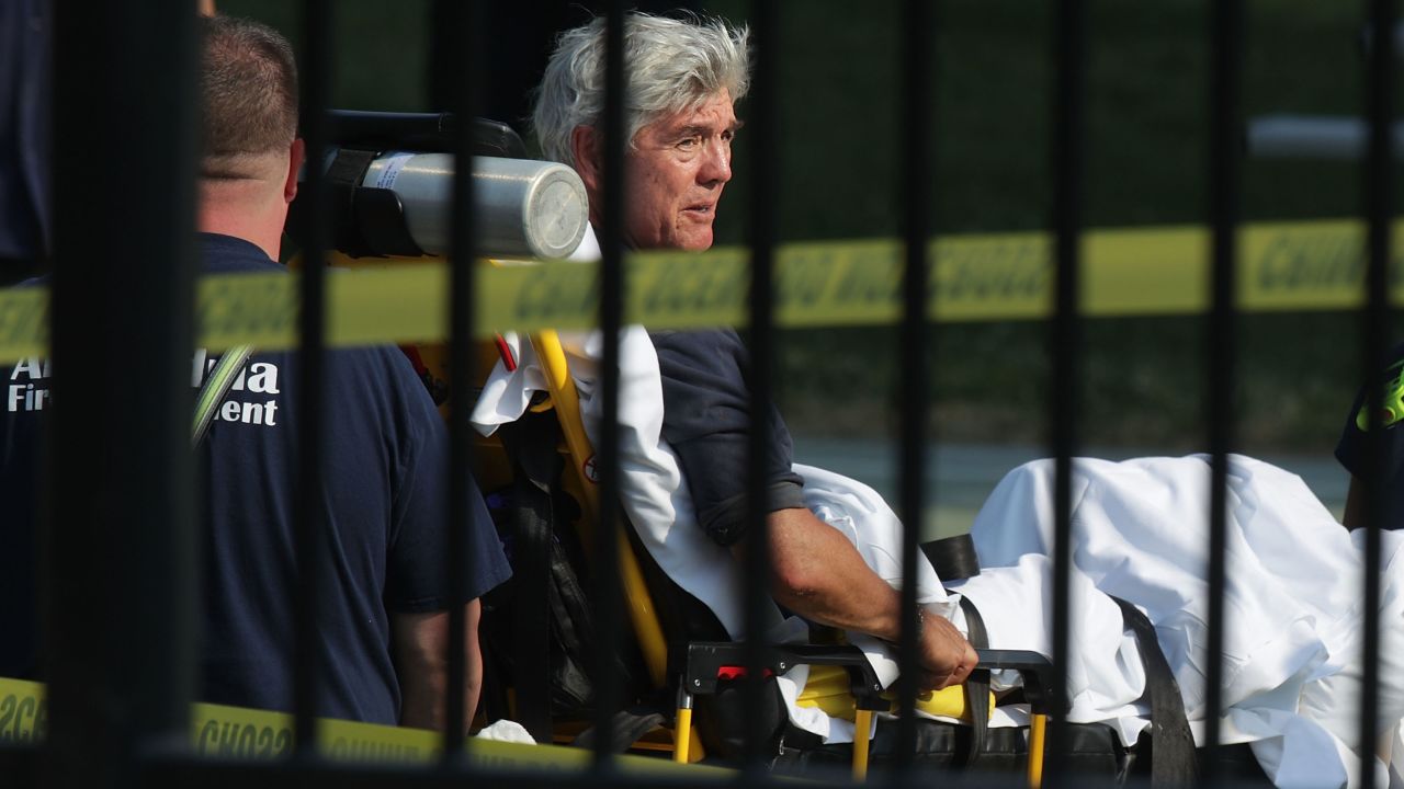 US Rep. Roger Williams is wheeled away by medical service personnel. In a statement, the Texas congressman said one of his staff members, legislative correspondent Zack Barth, was shot during the incident.