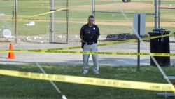 A police office stands watch behind police tape near strewn softballs on a field in Alexandria, Va., Wednesday, June 14, 2017, after a multiple shooting involving House Majority Whip Steve Scalise of La.