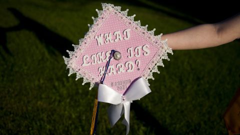 Grace Bannister shows off her graduation cap in her backyard in Chapmanville, West Virginia. Bannister graduated this year as valedictorian of her class and plans to attend Harvard University in the fall.