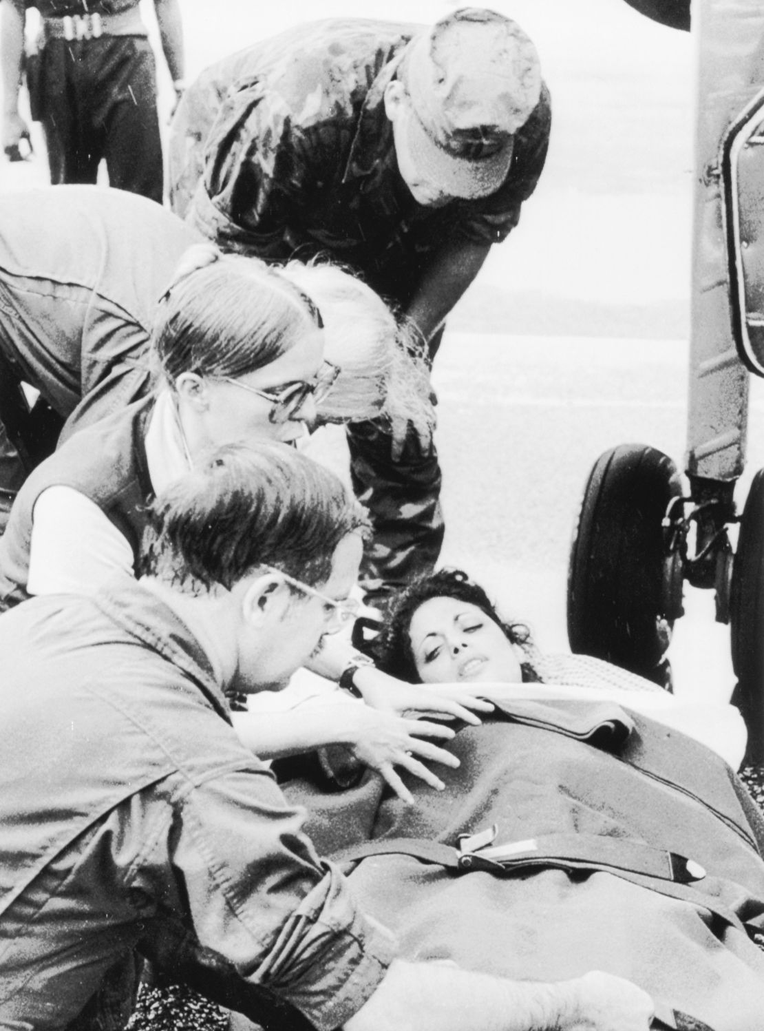 Jackie Speier, an aide to Congressman Leo Ryan, being taken from a plane at Georgetown on November 19, 1978, after its arrival from Jonestown where Speier was shot five times and Ryan and four others were ambushed and killed by members of the People's Temple. 