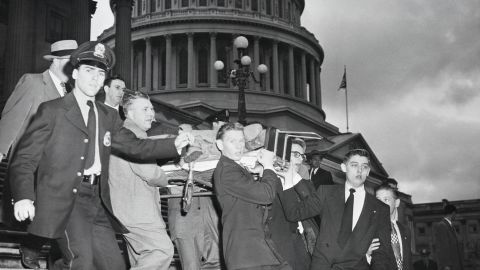 Rep. Kenneth Roberts shown here being carried down the Capitol steps after Puerto Rican nationalists opened fire in the Capitol Building, shouting "Free Puerto Rico."