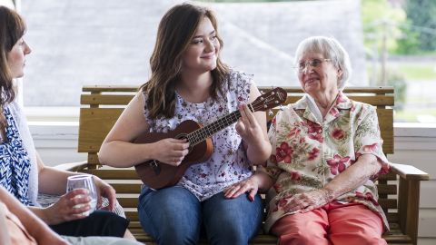 Emma Pino plays the ukulele next to her grandmother, Helen Romage, on her front porch in Mount Hope, West Virginia. Pino plans to attend West Virginia University in the fall, but says she'll likely leave the state after college. "I will probably always have family ties here so it will be hard to let all that go, but I think I need to."