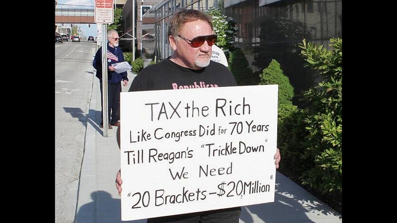 In this undated file photo, James Hodgkinson holds a sign during a protest outside a United States Post Office in Belleville, Illinois. 