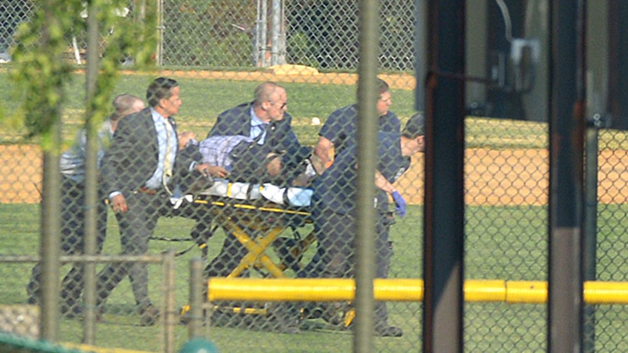 A wounded person is stretchered away from a baseball field in Alexandria, Virginia, on Wednesday, June 14. A gunman opened fire on Republican congressmen as they practiced baseball at the field. House Majority Whip Steve Scalise, a congressional staffer, a lobbyist and two members of the congressional police force were among those injured, officials said. The alleged gunman was killed.