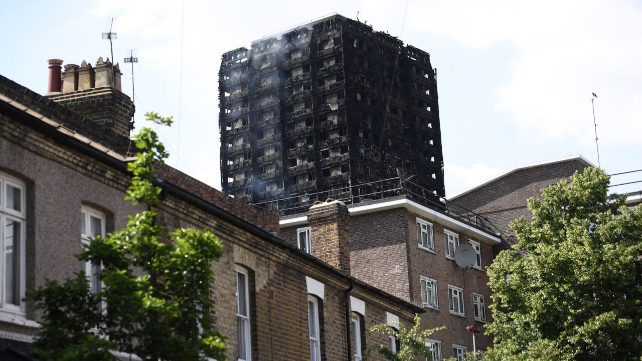 Smoke continues to rise from the 24-story residential Grenfell Tower in west London Wednesday afternoon.