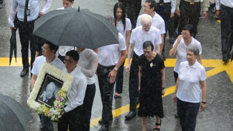 Lee Wei Ling (second from left), the younger sister of Singapore's Prime Minister Lee Hsien Loong, along with family members walking out of parliament house during the late founding father Lee Kuan Yew's funeral procession in Singapore in 2015. 