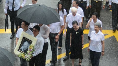Lee Wei Ling (second from left), the younger sister of Singapore's Prime Minister Lee Hsien Loong, along with family members walking out of parliament house during the late founding father Lee Kuan Yew's funeral procession in Singapore in 2015.