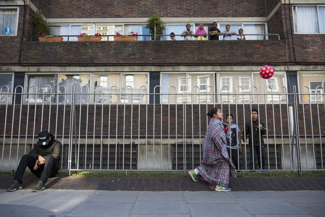 As adults gathered together in the street, children laughed and played.