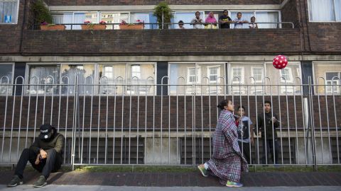 As adults gathered together in the street, children laughed and played.