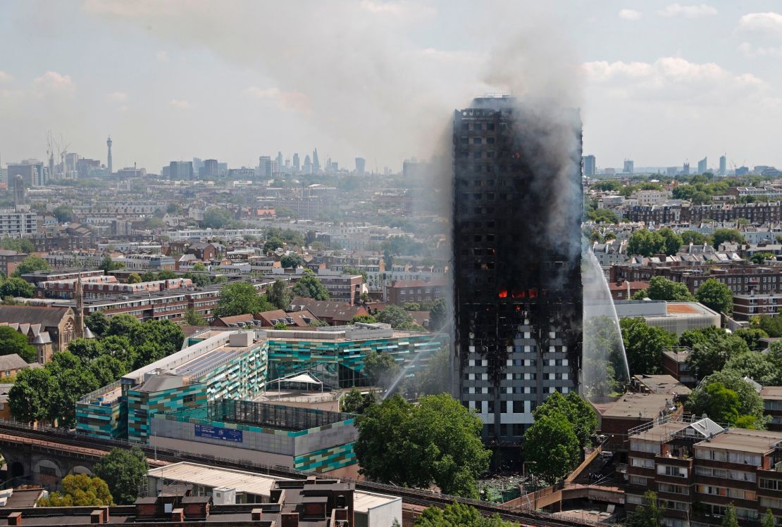 Smoke and flames billow from Grenfell Tower as firefighters attempt to control a blaze at the residential building on June 14, 2017.
