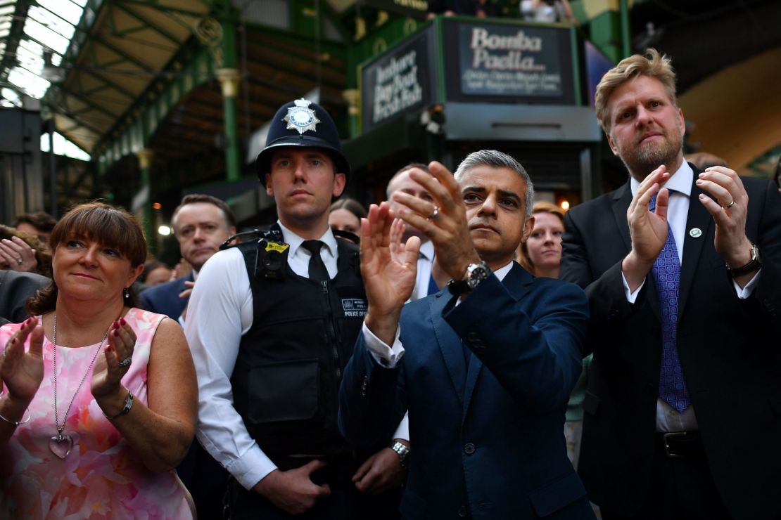Mayor Sadiq Khan applauds at the re-opening of Borough market before going to see the aftermath of the tower fire.