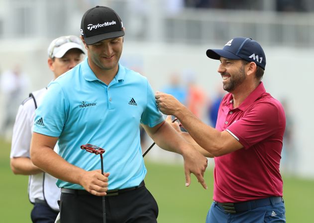 Rahm enjoys a joke with fellow Spaniard Sergio Garcia who finally clinched his first major title at the Masters tournament in April. 
