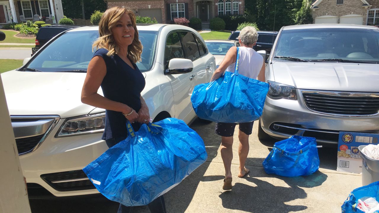 Meade carries bags during a volunteer effort with the Blessings in a Backpack organization.