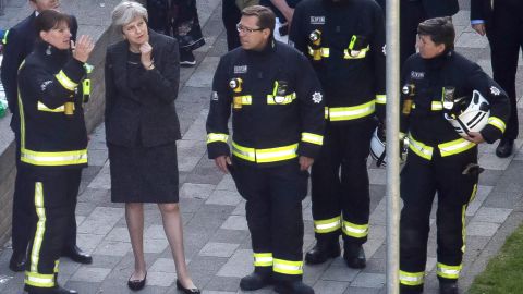 May consults with London Fire Commissioner Dany Cotton, left, at the scene of the fire Thursday.