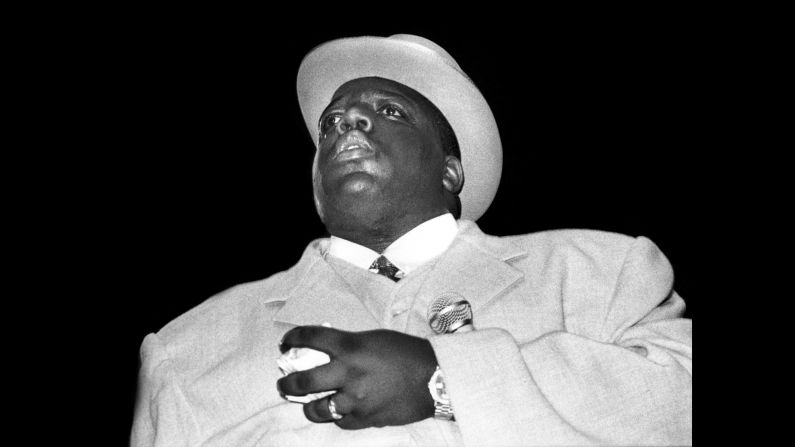 With hits like "Big Poppa" and "One More Chance," <a href="index.php?page=&url=http%3A%2F%2Fwww.cnn.com%2F2017%2F03%2F09%2Fentertainment%2Fnotorious-big-20-year-anniversary%2Findex.html">Christopher Wallace (aka The Notorious B.I.G.)</a> rose to hip hop superstardom in the mid-'90s. Shown here performing on June 29, 1995, Wallace was signed to Sean "Diddy" Combs' record label, Bad Boy Records, and was a central figure in the decade's tense East Coast-West Coast hip hop war. Just six months after Tupac Shakur was shot and killed in Las Vegas, Wallace was gunned down in Los Angeles in 1997. And like Shakur's death, Wallace's killing remains unsolved.<br />
