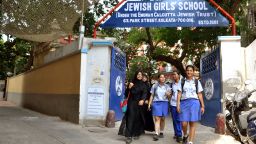 Muslim girls, some in the burqa and some in the regular uniforms, leave the Jewish Girls School in Calcutta. 