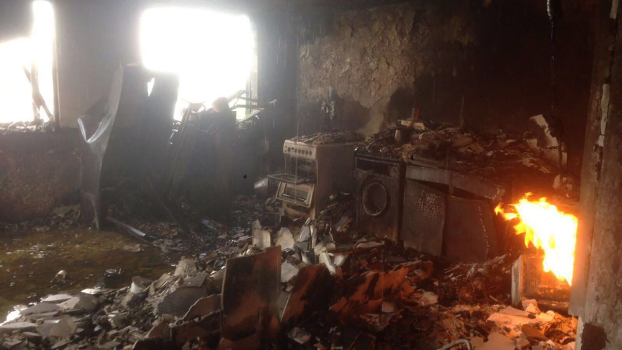 Fire still burns inside one of the flats in the Grenfell Tower.