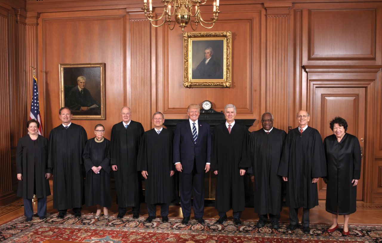 Trump stands with the Supreme Court at Gorsuch's formal investiture ceremony in June 2017. From left are Elena Kagan, Samuel Alito, Ruth Bader Ginsburg, Kennedy, Chief Justice John Roberts, Trump, Gorsuch, Clarence Thomas, Stephen Breyer and Sonia Sotomayor.