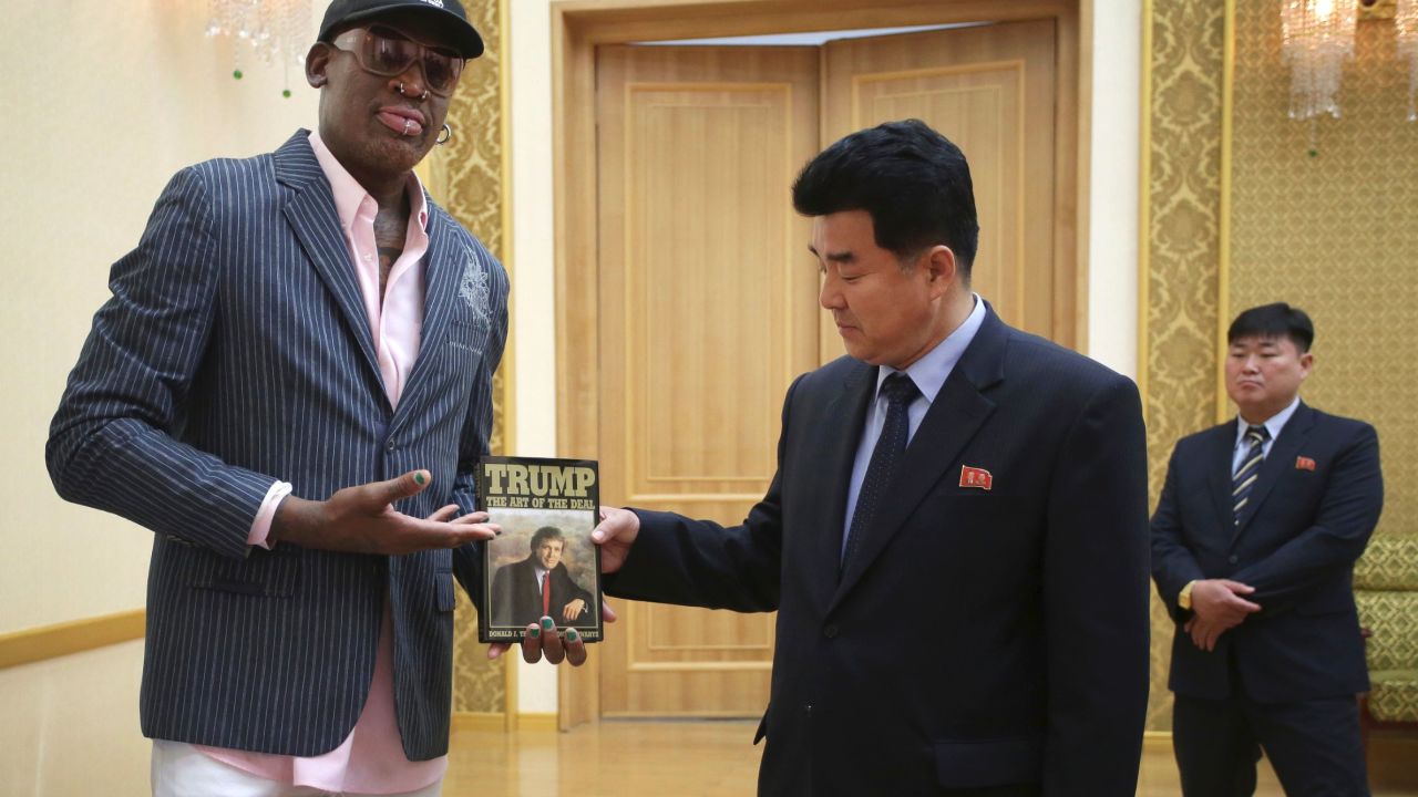 Former NBA basketball star Dennis Rodman presents a book titled "Trump The Art of the Deal" to North Korea's Sports Minister Kim Il Guk Thursday, June 15, 2017, in Pyongyang, North Korea. (AP Photo/Kim Kwang Hyon)