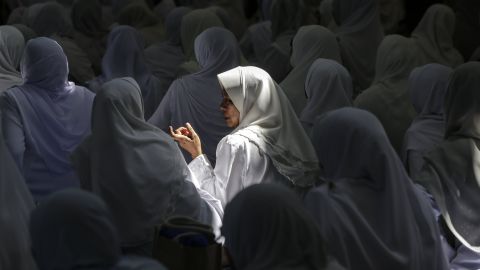 Women chat at a mosque in Kuala Lumpur, Malaysia, during a Quran-reciting program on Sunday, June 11. Ramadan, the most sacred month in the Muslim year, ends on June 24.