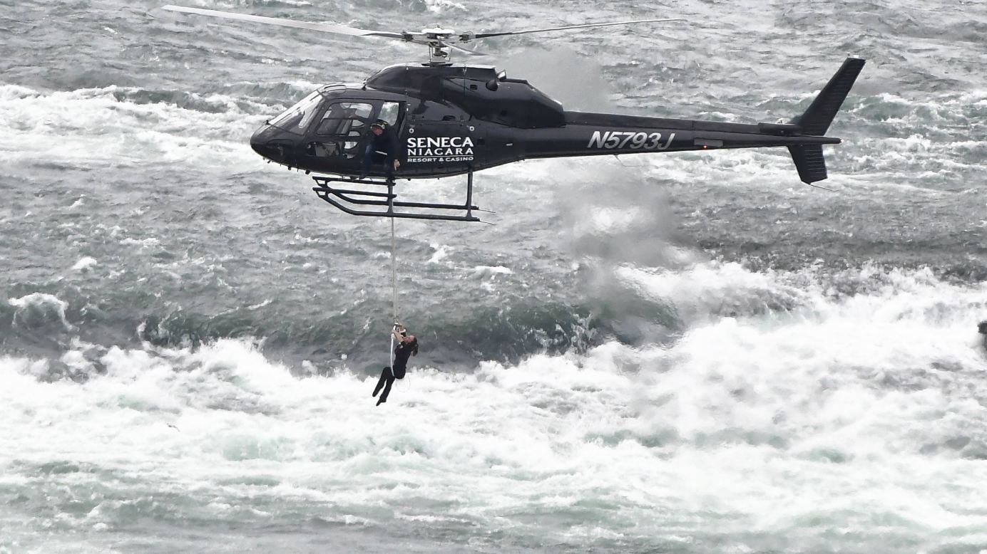 Acrobat Erendira Wallenda hangs above the Niagara River in Niagara Falls, New York, on Thursday, June 15. At one point she even hung on by her teeth. Watching from the helicopter is her husband, daredevil Nik Wallenda.