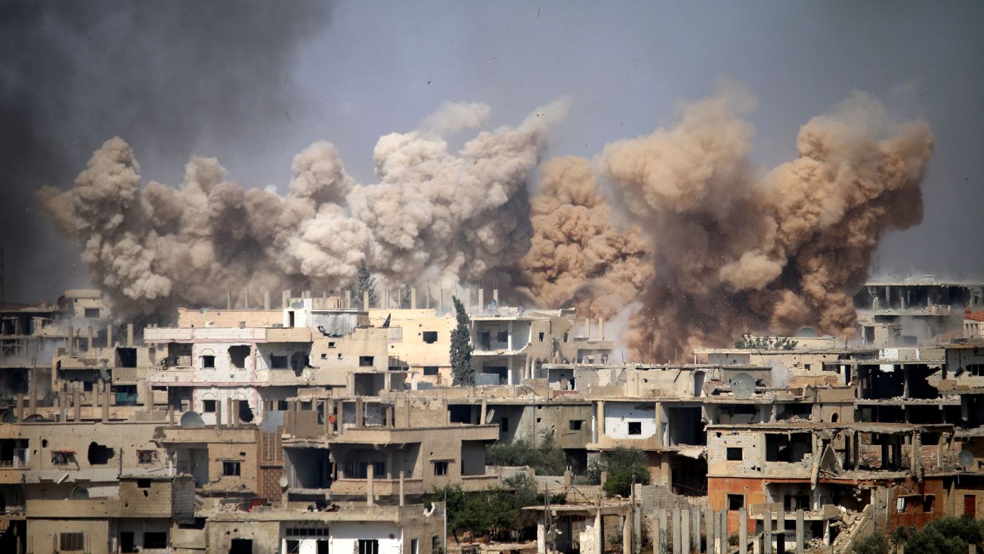 Smoke rises from buildings after a reported airstrike on a rebel-held area of Daraa, Syria, on Wednesday, June 14.