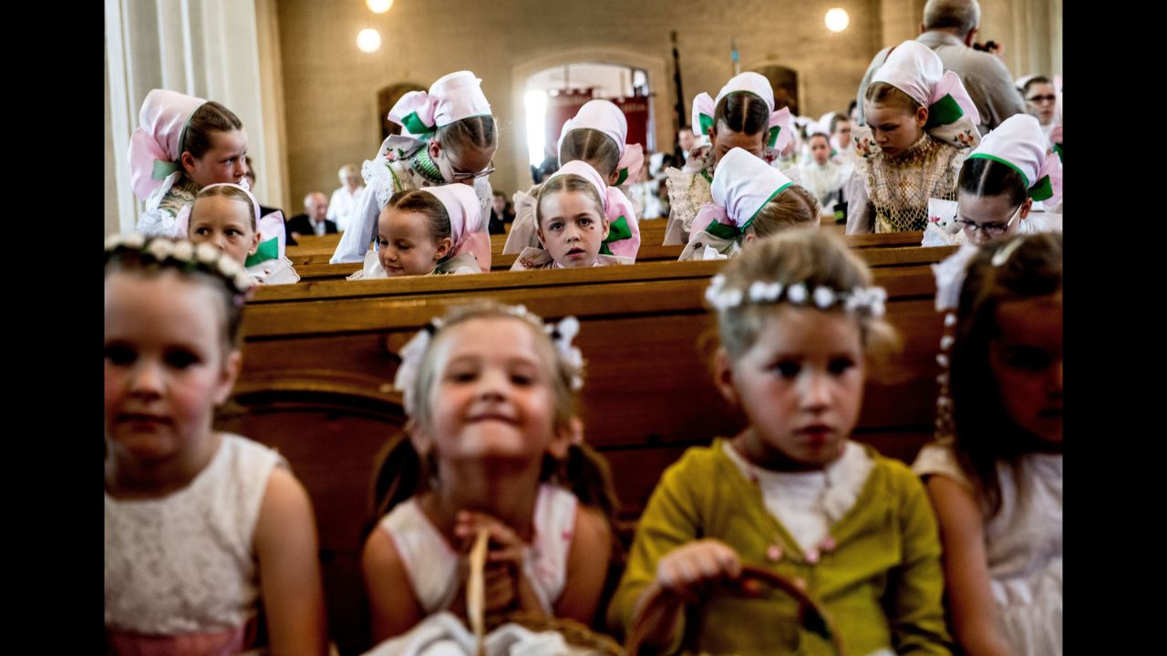 Children attend a Catholic Mass during a Corpus Christi procession in Crostwitz, Germany, on Thursday, June 15.
