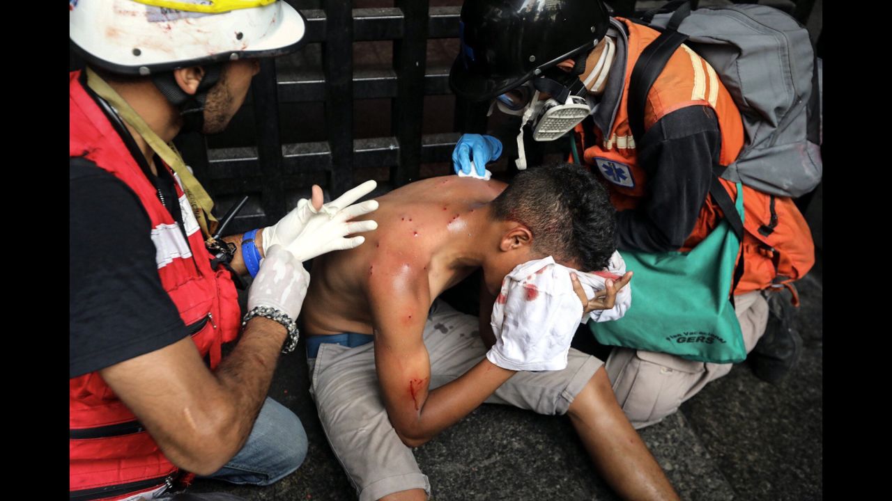 An injured man receives medical attention during a protest in Caracas, Venezuela, on Monday, June 12. The country's Supreme Court had rejected a chief prosecutor's motion that would prevent President Nicolas Maduro from rewriting the constitution. Venezuela <a href="http://www.cnn.com/2017/04/12/world/gallery/venezuela-protests/index.html" target="_blank">has been in a state of widespread unrest </a>since March.