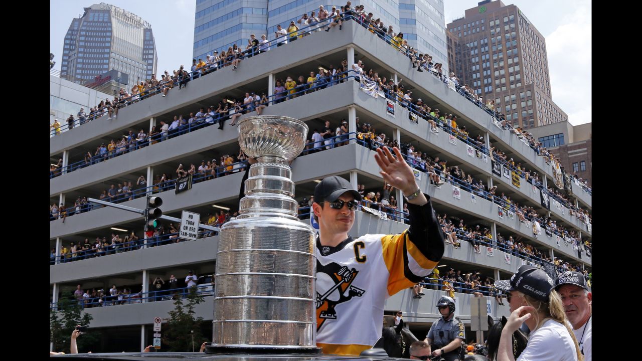 Sidney Crosby, captain of the Pittsburgh Penguins, waves to fans during the hockey team's Stanley Cup parade on Wednesday, June 14. The Penguins also won the championship last year.