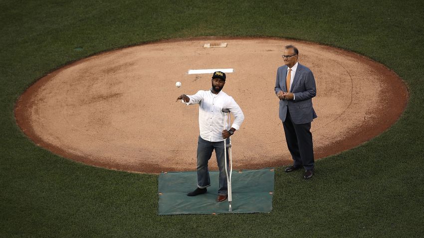 WASHINGTON, DC - JUNE 15:  U.S. Capitol Hill special agent David Bailey (L), who was wounded in yesterday's shooting, throws out the first pitch before the Congressional Baseball Game at Nationals Park on June 15, 2017 in Washington, DC. Bailey and special agent Crystal Griner were assigned to U.S. Rep. Steve Scalise (R-LA) and returned fire during the attack. Scalise is in critical condition following a shooting yesterday during a Republican congressional baseball team practice.  (Photo by Win McNamee/Getty Images)