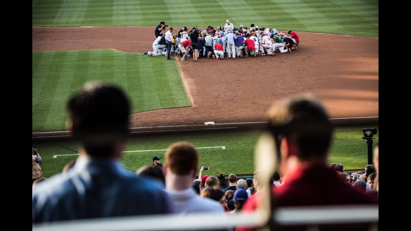 A prayer is held before the start of <a href="http://www.cnn.com/interactive/2017/06/politics/congressional-baseball-game-cnnphotos/index.html" target="_blank">the annual Congressional Baseball Game,</a> which took place at Nationals Park in Washington on Thursday, June 15. Democrats and Republicans played the charity game a day after a gunman opened fire at a GOP practice, injuring US Rep. Steve Scalise and several other people.