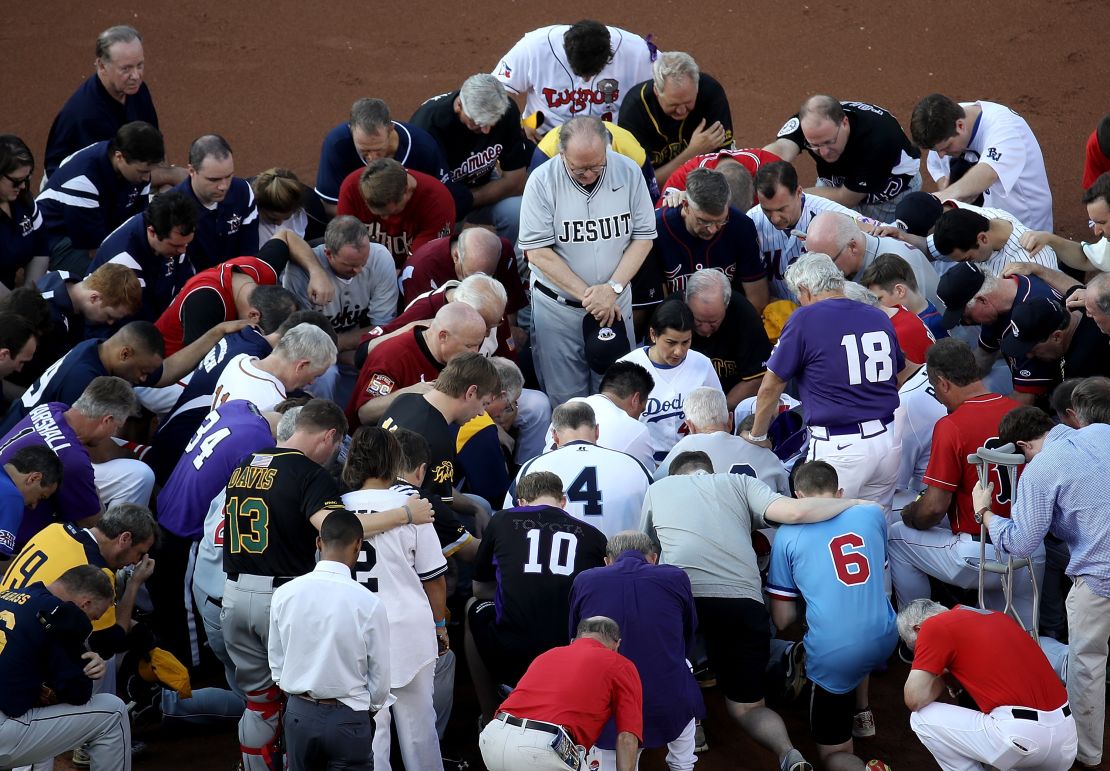 WASHINGTON, DC - JUNE 15:  Members of the Republican and Democratic congressional baseball teams gather for a bipartisan prayer before the start of the Congressional Baseball Game at Nationals Park on June 15, 2017 in Washington, DC. U.S. House Majority Whip Rep. Steve Scalise (R-LA) is in critical condition following a shooting yesterday during a Republican congressional baseball team practice.  (Photo by Win McNamee/Getty Images)