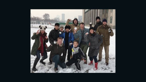Otto Warmbier, fourth from the right in a blue jacket, throws a snowball in this photo from his trip to North Korea.
