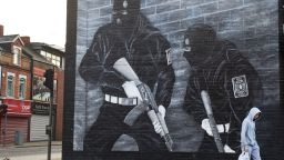 BELFAST, NORTHERN IRELAND - SEPTEMBER 21:  A man walks past a paramilitary mural on the Newtownards road on September 21, 2015 in Belfast, Northern Ireland. The Northern Irish political parties resumed round table talks today after the government commissioned an independent assessment of paramilitary activity. Arrests have been made after police found Semtex and other weapons in West Belfast last Thursday.  (Photo by Charles McQuillan/Getty Images)