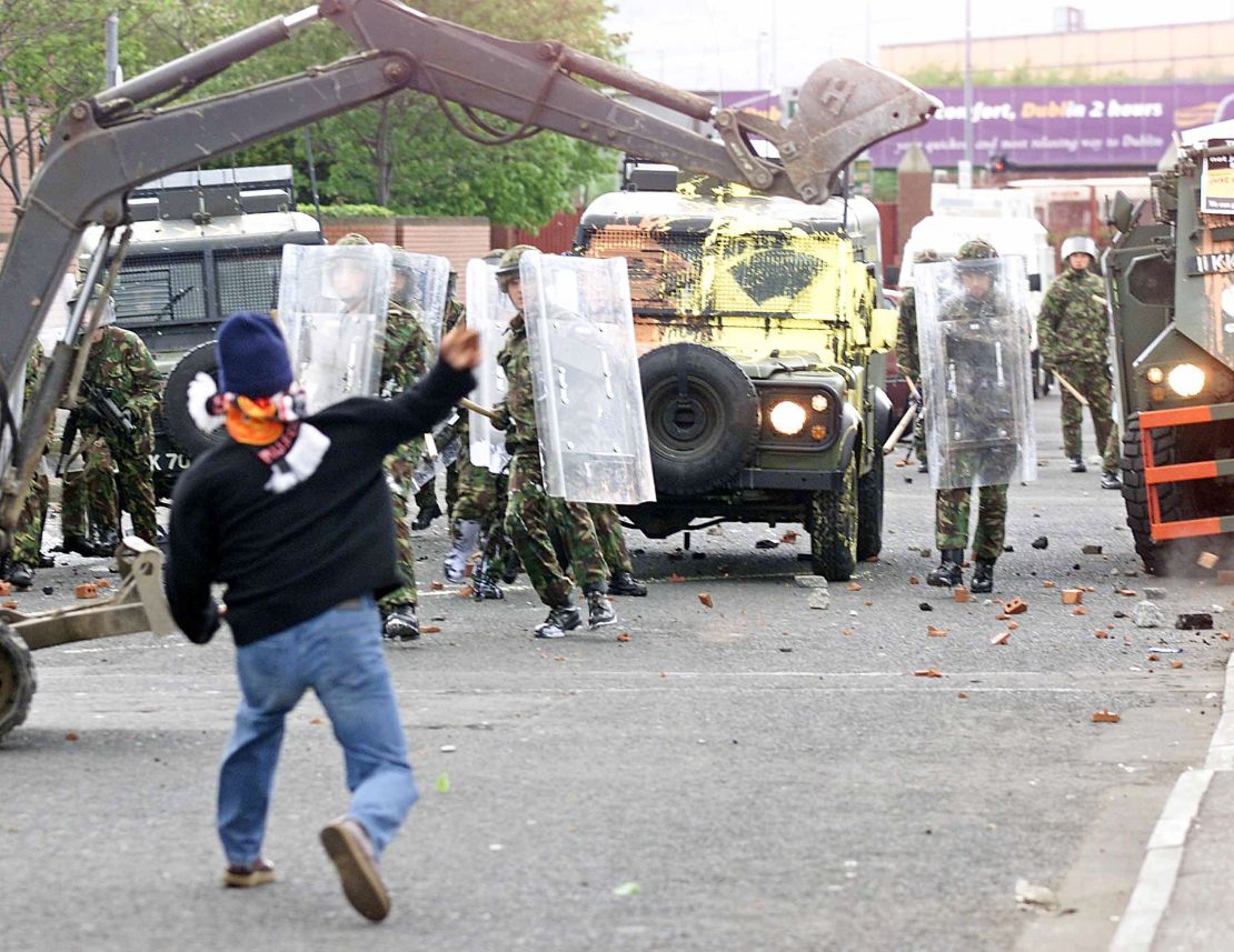 Republican protesters throw stones at British soldiers in 2002. 