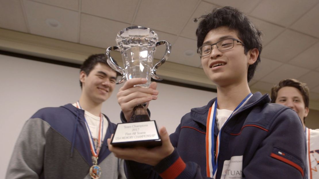 Tuan Bui holds a trophy at the USA memory championships.