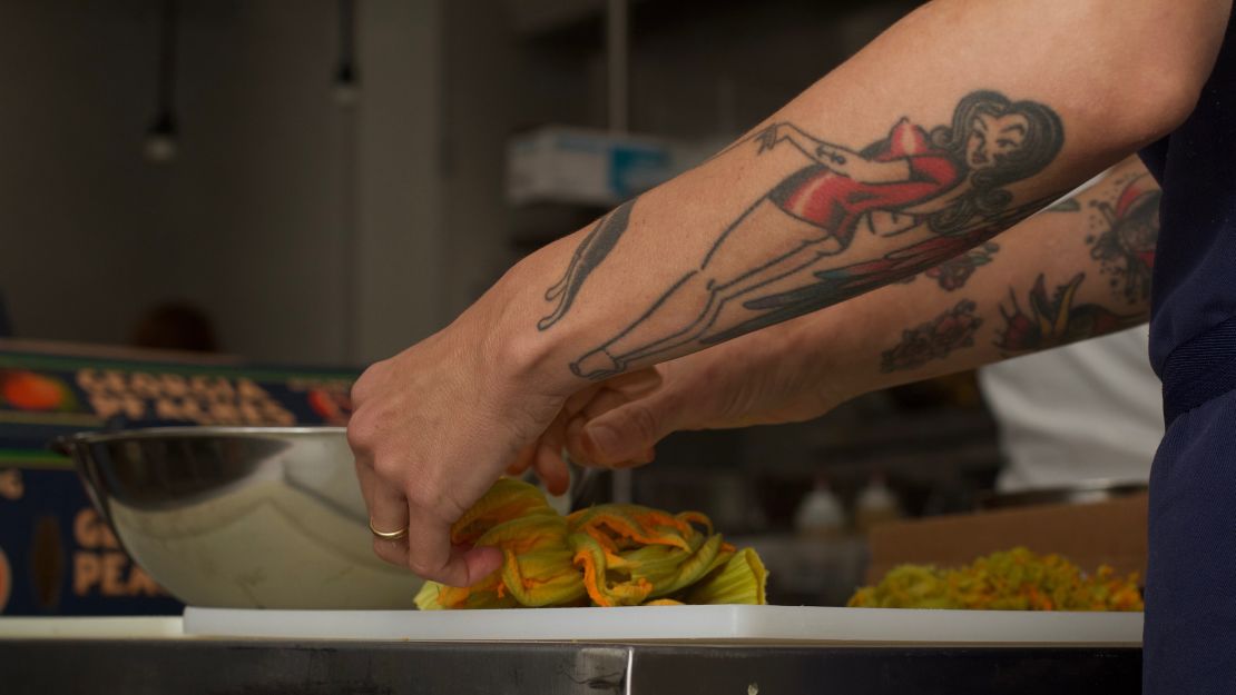 Chef Whitney Otawka prepares squash blossoms for a dish. 