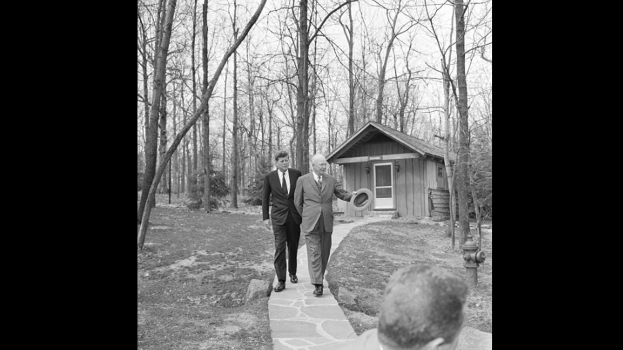 President John F. Kennedy walks the grounds, getting a tour from Dwight D. Eisenhower, as the two discussed Cuba, three months after Kennedy won the election.