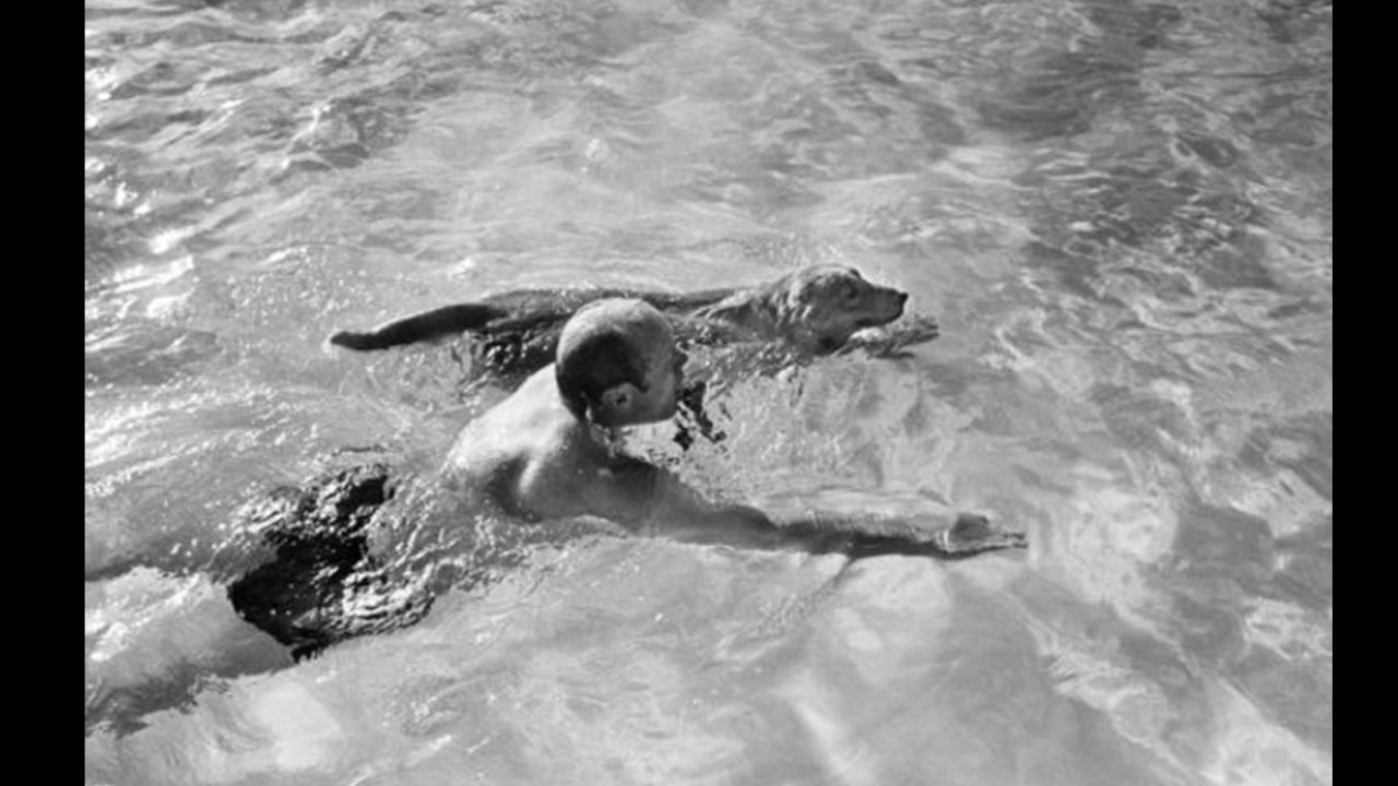 Ford again taking in some recreation, swimming with his dog, Liberty, in February 1974. 
