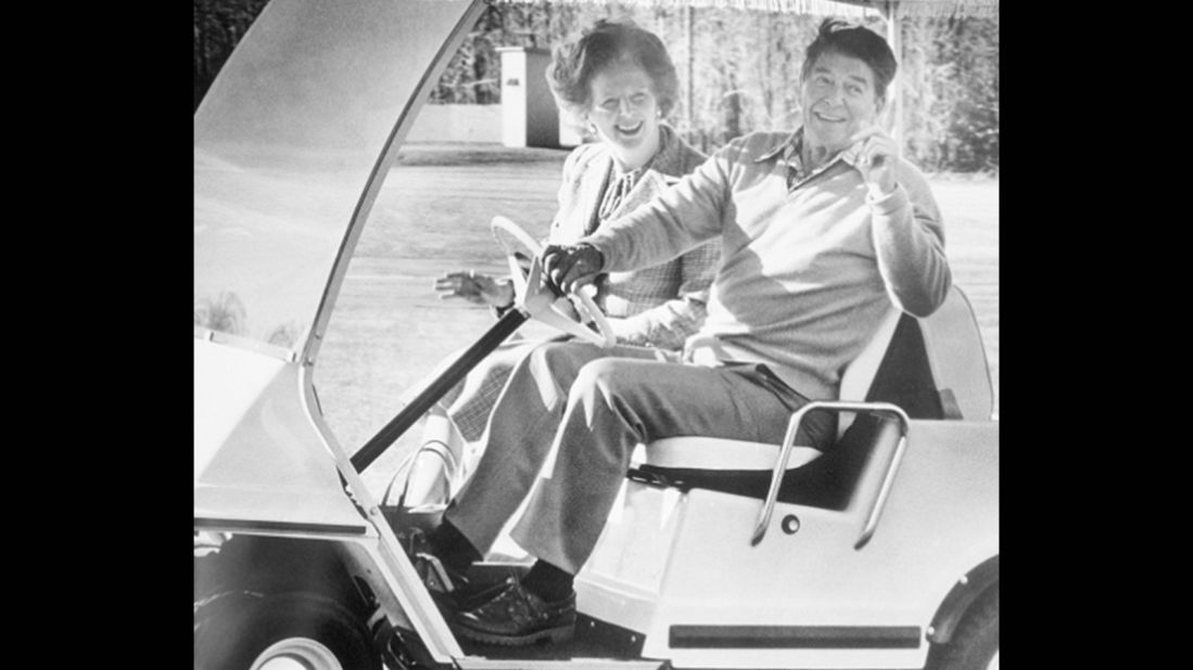 President Ronald Reagan takes British Prime Minister Margaret Thatcher for a spin in his golf cart, December 1984. 