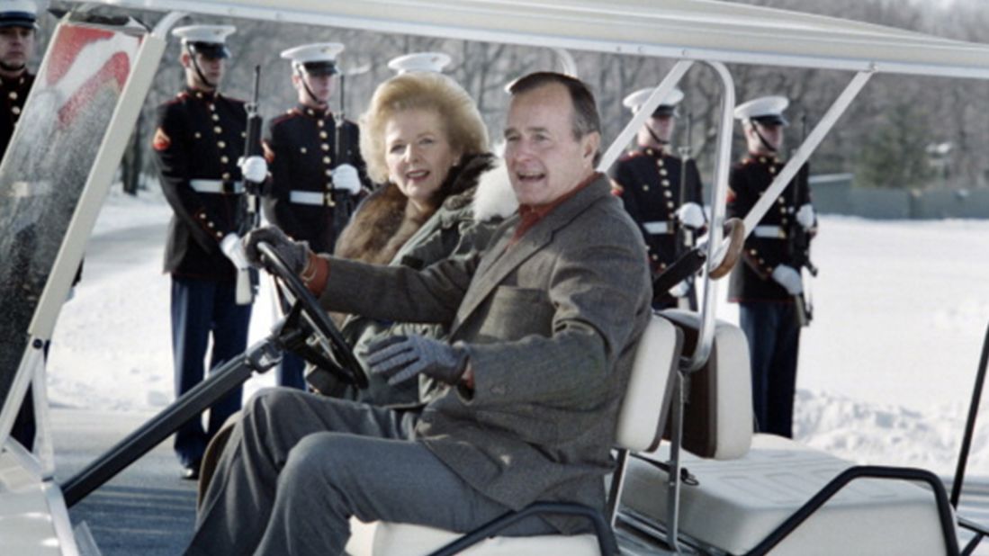 President George H.W. Bush takes British Prime Minister Margaret Thatcher for a spin in his golf cart in November 1989.