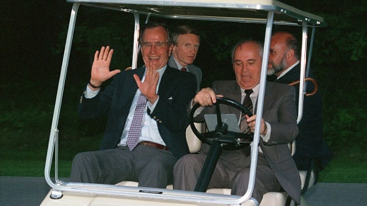 President George H.W. Bush lets Russian President Mikhail Gorbachev take the wheel of the golf cart in June 1990.