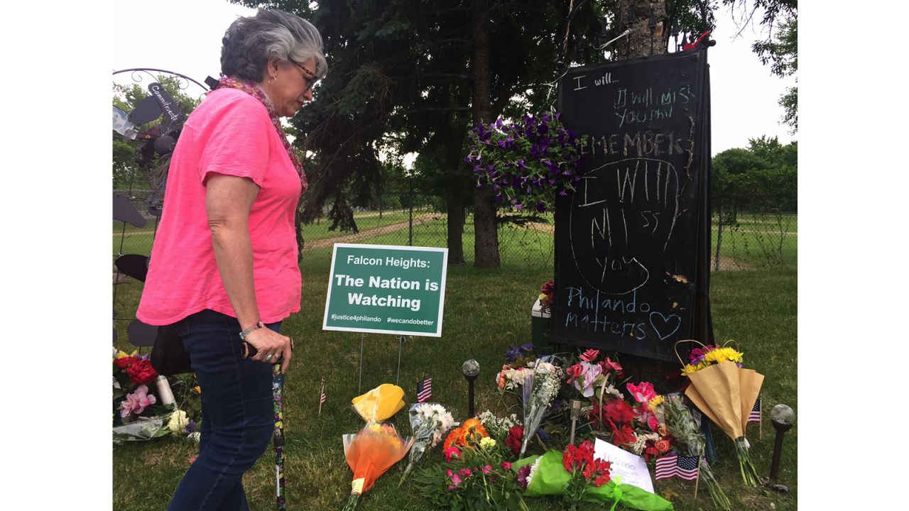 Theresa St. Aoro visits the memorial to place flowers at the site where Philando Castile was shot.