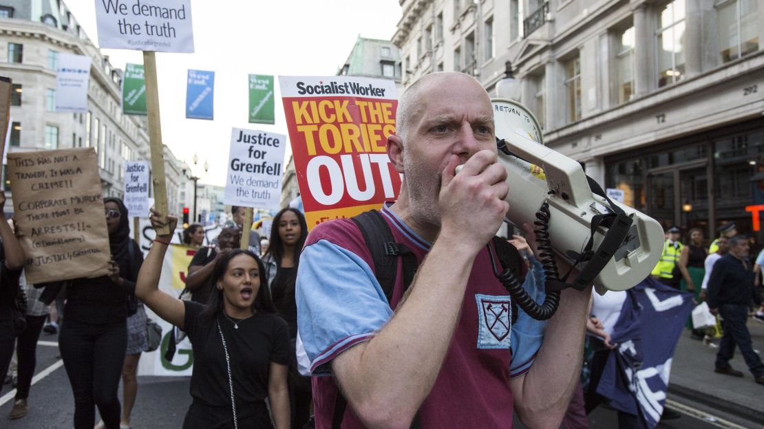 Protester Michael Bradley leads the Grenfell Tower demonstrators down Regent Street in central London.