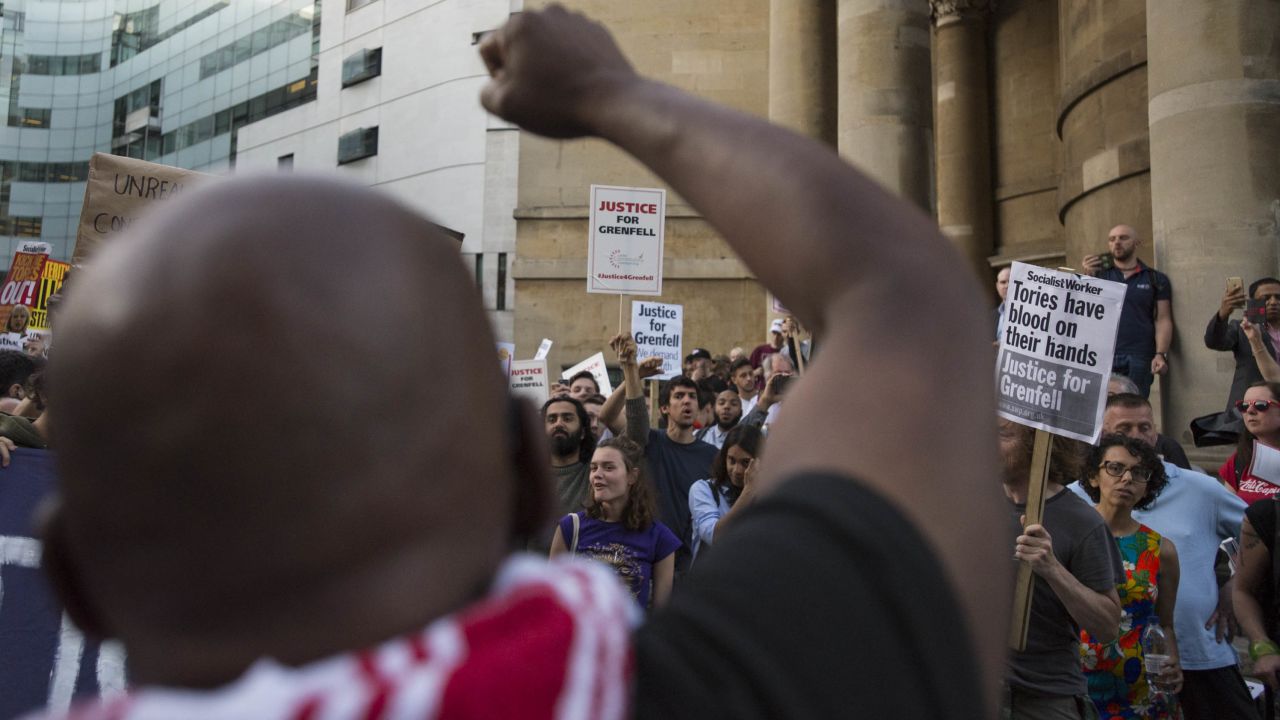 A protester leads a chant, "Justice for Grenfell!" outside the BBC headquarters in central London.