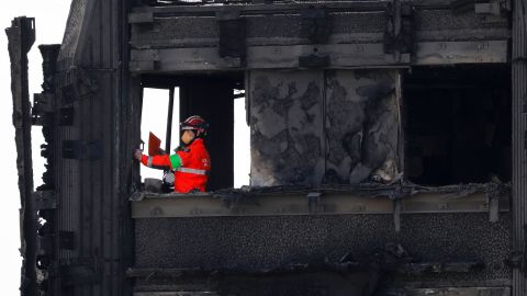 Members of the emergency services work on the top floor of the gutted Grenfell Tower on June 17.