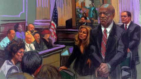 In an artist's sketch, Bill Cosby stands before the court. 