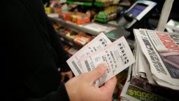 CHICAGO, IL - JANUARY 9 : A customer shows off his Powerball tickets at a 7-Eleven store January 9, 2016 in Chicago, Illinois. The Powerball Jackpot Surged to a record $900 Million in 44 States, Washington D.C., Puerto Rico, and the US Virgin Islands before tonight's drawing. (Photo by Joshua Lott/Getty Images)