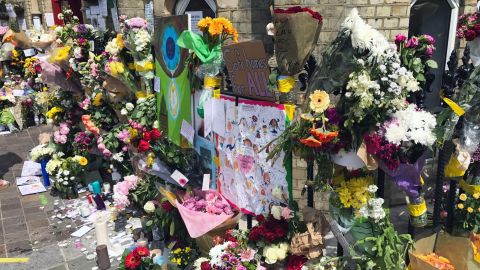 Flowers are placed outside the Notting Hill Methodist Church in west London on Sunday 18 June as a memorial to those who died in Grenfelll Tower fire.